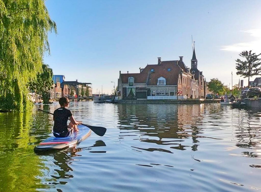 Boy on a SUP in a city